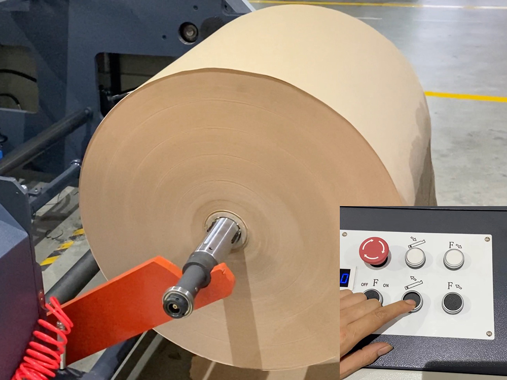 Paper Bag Machine showing a large paper roll feed and an operator pressing a control button